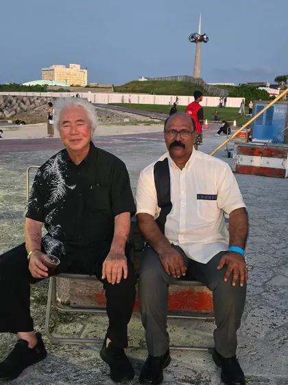 A moment of quiet conversation during the Okinawa tournament. Sharing insights with masters from different styles is always an enlightening experience.