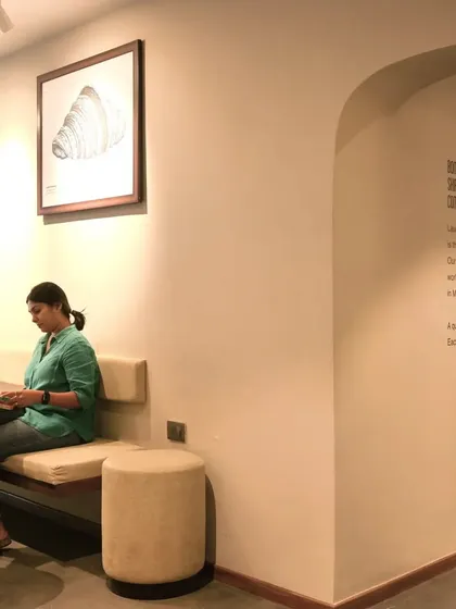 A quiet seating area within the Subko Coffee space, where framed art and minimalist furniture create a gallery-like feel.