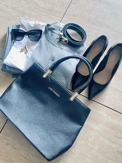 This flat lay shows how to elevate a monochrome grey and black outfit. By adding touches of gold through accessories like cufflinks and a belt buckle, and pairing with classic black pumps, the look becomes instantly more glamorous.