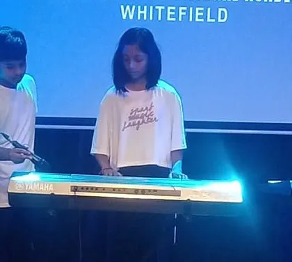 Students demonstrate their new musical talents on the keyboard during the summer camp showcase.