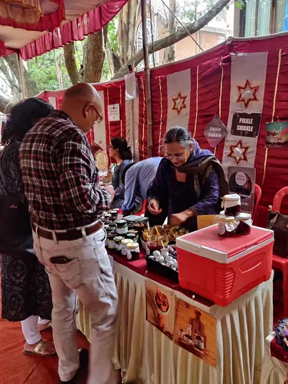 Here I am, all smiles, while serving samples at a market. Letting people taste the difference is the best way to show the quality of my homemade pickles.