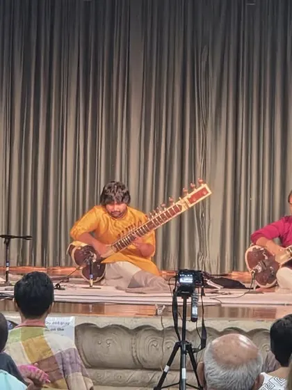 Performing for a full audience in St. Louis. You can see the classic trio format: my brother and I on sitar, with our accompanist on tabla, creating a complete classical music experience.