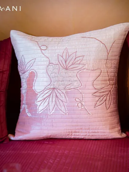 The velvety softness of this pink cushion, adorned with intricate lotus motifs, invites you to indulge in moments of pure relaxation. It is a piece of art that celebrates the quiet beauty of nature.