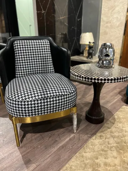 A single houndstooth accent chair paired with a matching side table. This combination creates a chic and stylish corner, perfect for enjoying a cup of coffee.