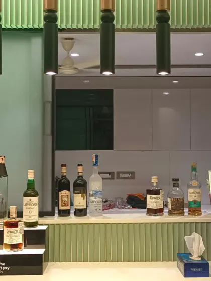 A clean and modern home bar setup. We stock the bar with a curated selection of spirits and provide a clear, easy-to-read menu for guests to choose their drinks.