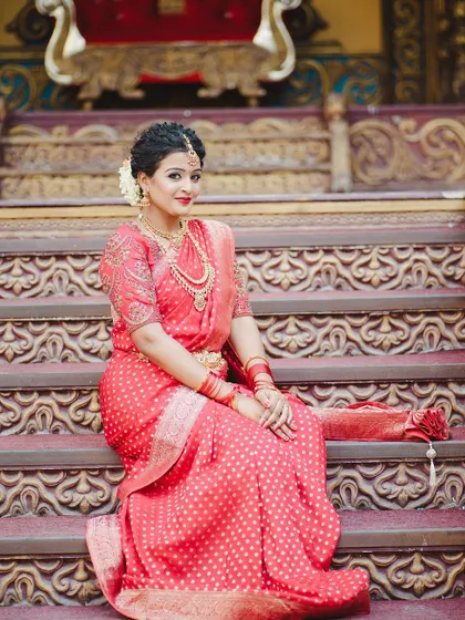 A regal pose in a classic red silk saree, perfect for a bride on her wedding day.