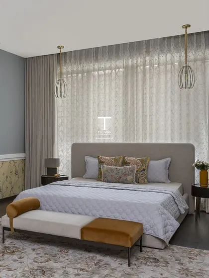 This bedroom is a perfect example of chic and practical design. We crafted the bed with an extended headboard, a comfortable ottoman for the foot of the bed, and sleek bedside tables for a complete and luxurious look.