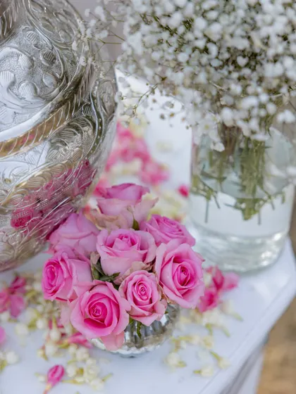 A close-up of the decor details. Pink roses and baby's breath in silver vases added a touch of softness to the minimal theme.