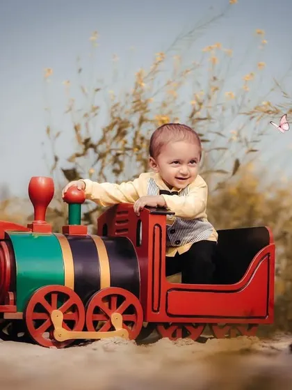 Chasing butterflies from his toy train. This shot is full of movement and wonder, capturing the magic of childhood imagination.