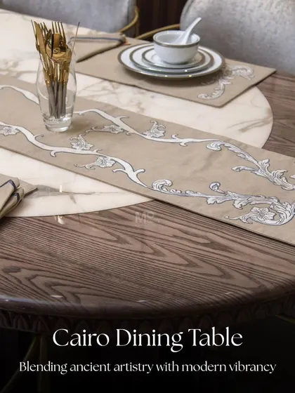 A detailed look at the Cairo Dining Table's surface, showing the distinctive interplay between the marble's natural veins and the wood's warm grain. The custom table runner adds another layer of bespoke elegance.