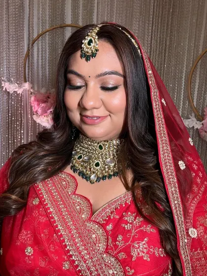 A classic bridal look for a phera ceremony. I created a soft smokey eye with a hint of shimmer and paired it with a neutral lip to balance her heavy jewelry and bold red outfit.