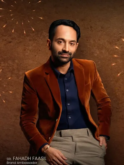 A promotional shot for Kavitha Gold & Diamonds featuring Fahadh Faasil. For male grooming in commercial shoots, the goal is a natural, polished finish that looks clean and professional on camera.
