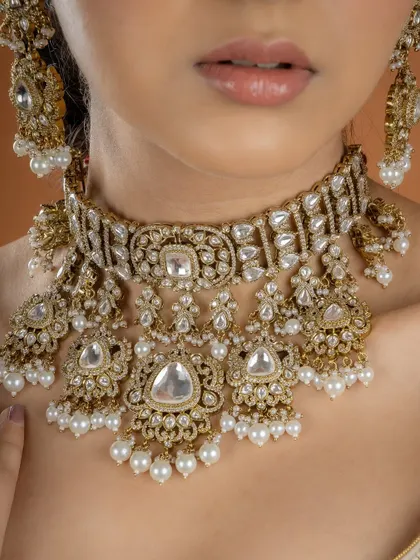 A detailed close-up of our classic Kundan and pearl choker. You can see the fine workmanship in the setting of each uncut stone and the delicate pearl drops.