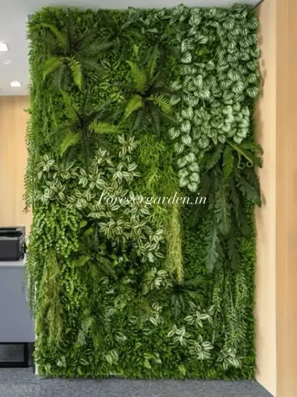 An artificial vertical garden installed in an office space, adding a refreshing natural element next to a workspace and doorway.