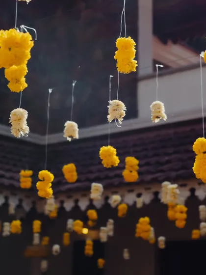 A ceiling of hanging marigold and tuberose buds, creating a beautiful floral canopy.