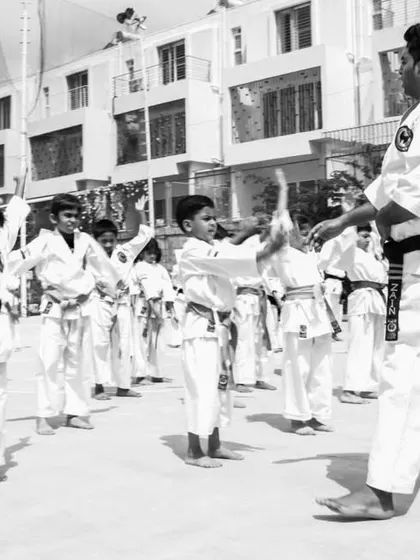 I personally guide my students to ensure their form is correct. Here, I am instructing a class of young beginners.