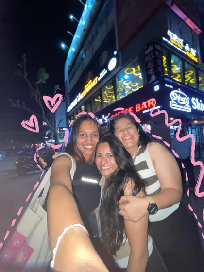 A happy group selfie with friends on a night out.
