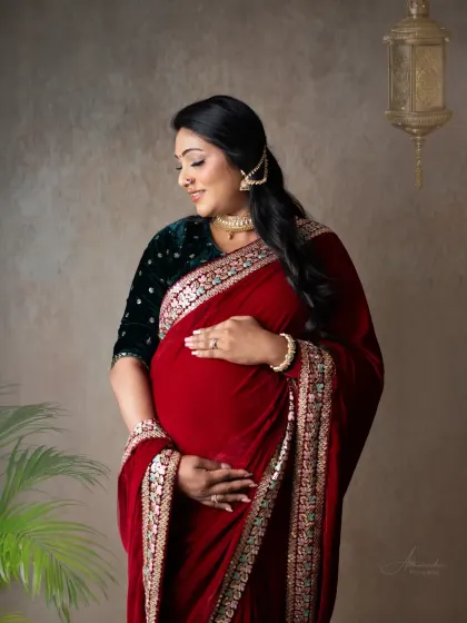 A stunning portrait in a rich, red velvet saree. The intricate border and the traditional jewelry complete this look of timeless grace and elegance.