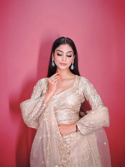 A portrait in the golden lehenga, highlighting the soft and glowing makeup look.