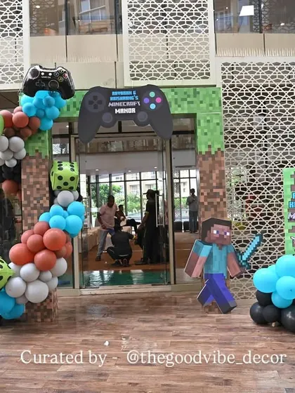 The entrance to the Minecraft party, featuring a balloon arch with game characters and dice, setting the tone for an adventurous celebration from the moment guests arrived.