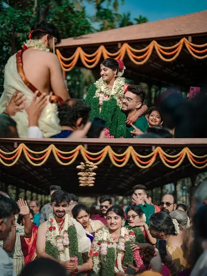 The joyful and energetic moment when the groom is lifted on the shoulders of his family during the wedding celebrations.
