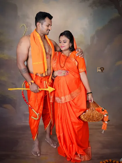 A powerful and divine pose from our Seetha-Ram theme. The dad-to-be holds a bow and arrow, symbolizing protection, as he stands with his partner.