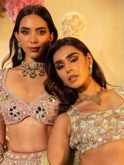 A shot of two models from the Surabhi Chopra lookbook. This highlights how different pieces from the same collection can be styled to create complementary looks, perfect for bridesmaids.