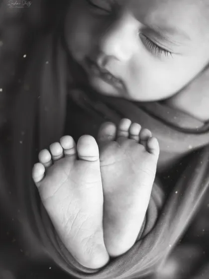 The same adorable feet, presented in a classic black and white edit. Monochrome photos offer a timeless, artistic quality that focuses on the form and texture of your baby's tiny features.