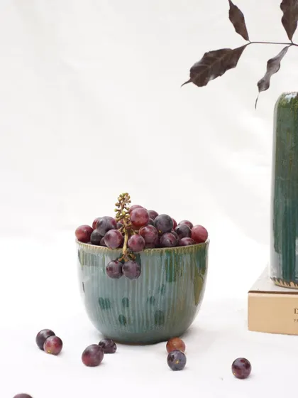 This bowl, filled with grapes, highlights the food safe quality and beautiful finish of our Lush Green glaze. The vertical carved lines interact wonderfully with the glossy surface.