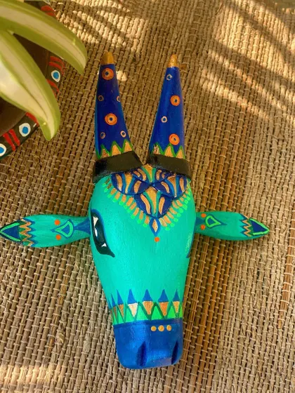 A duplicate image of the teal and blue Nandi on a jute background.