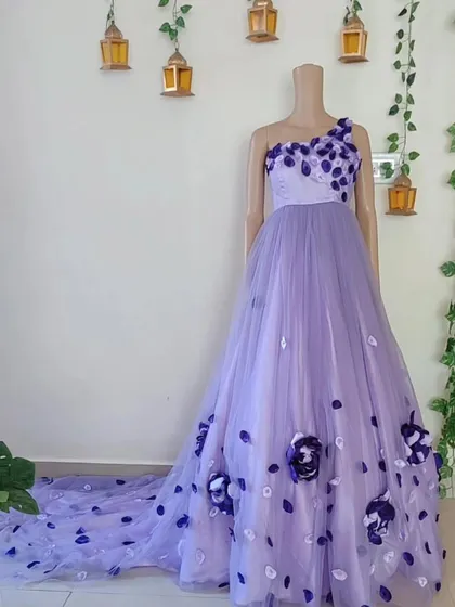 My signature lavender gown with 3D flowers, as seen on a mannequin. This shows the one-shoulder design and the beautiful way the flowers cascade down the dress.