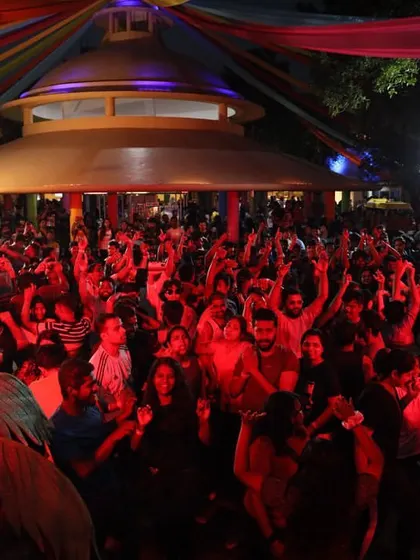 A wide shot of the audience at Wonderla, showing the scale of the event under the colorful tent.