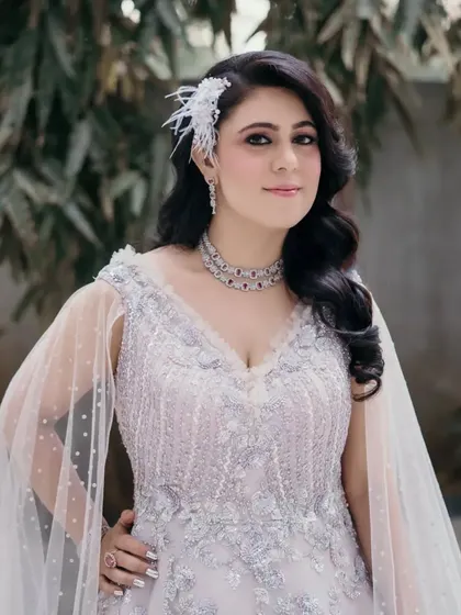 A final look at the client's stunning hairstyle and gown. The combination of the detailed dress and the classic Hollywood waves is perfect for making an entrance.