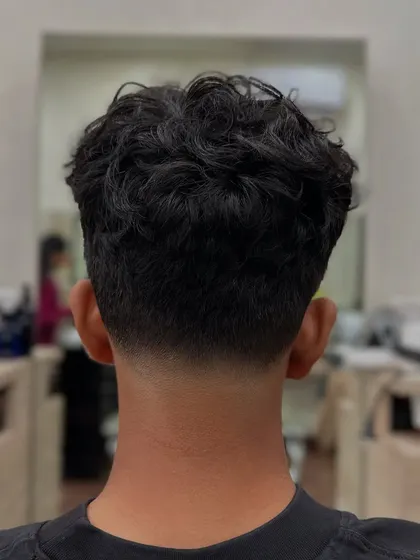 The view from the back showcases the flawless graduation of the taper fade. We focus on creating a smooth blend that grows out well, whether you have straight or curly hair.
