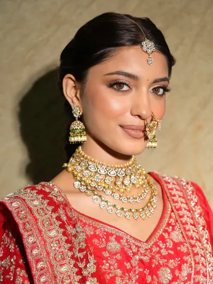 A classic bridal portrait. The makeup is minimal yet impactful, with a focus on glowing skin and defined eyes.