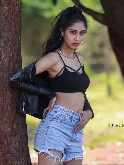 A casual outdoor portrait with a modern, edgy style. The natural setting provides a great contrast to the fashion look.