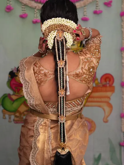 The back view showcases the beautiful bridal braid accessory, which is an important part of the complete look.