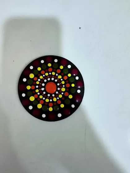 This is a finished piece from my dot Mandala workshop. Using simple tools, we build up the design dot by dot, creating a beautiful, textured artwork on a coaster.