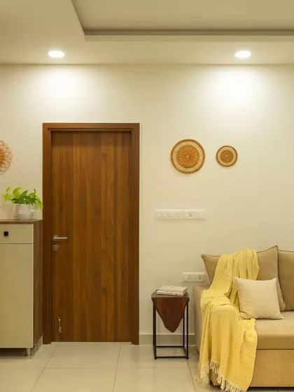 A wider view of the 'Bohemian Bliss' living area, showing the cohesive design from the entryway to the sofa. The space feels connected and harmonious.