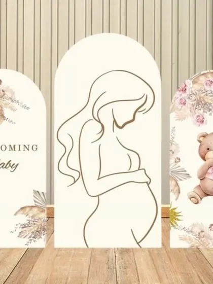 A design concept for a modern, boho-chic baby shower. This triptych backdrop features line art of a mother-to-be, pampas grass designs, and a cute teddy bear.