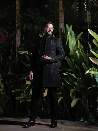 A client ready for his evening event in a fully embroidered black sherwani. The tone-on-tone detailing creates a look that is both luxurious and understated.