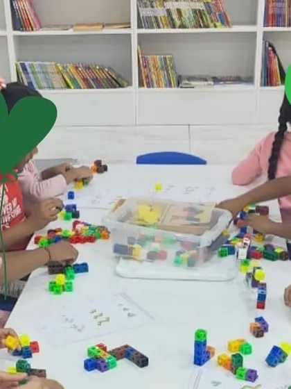 Children at Made for Kids Bookstore engaged in a workshop using connecting cubes. Bookstores can be wonderful community hubs for learning and play.
