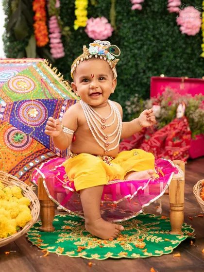 A happy little Kanha on his throne. The colorful, traditional props I use for Janmashtami shoots create a truly festive atmosphere.