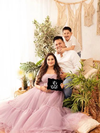 A fun and candid family moment during a maternity shoot. The older brother's playful energy brings so much life to the photograph.