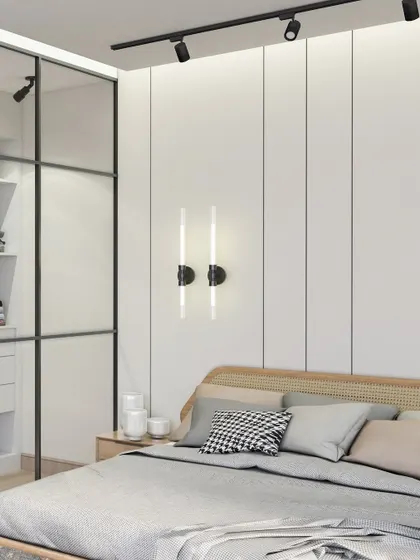 A closer look at the details in this Scandinavian bedroom. The vertical wall paneling behind the bed adds subtle texture, while the modern wall sconces provide soft, ambient lighting perfect for winding down.