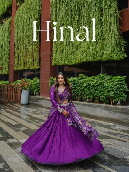 A stunning portrait of the bride-to-be, Hinal, twirling in her vibrant purple lehenga. This shot captures the joy and beauty of her virtual engagement day.