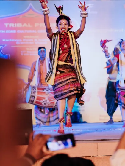A dancer leaps into the air with infectious energy during a cultural celebration at Kartavya Path. Freezing these peak action moments makes for incredibly dynamic event photos.