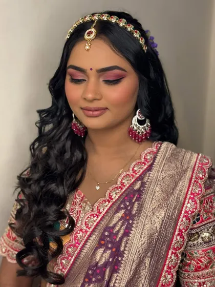 The complete mehendi look. The soft, radiant makeup and intricate hairstyle perfectly complement her vibrant, festive outfit.