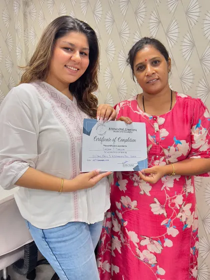 A proud moment for Sanjana as she receives her certificate of completion. She is now equipped to add professional nail services to her makeup artistry business.