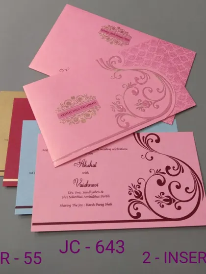 This pink invitation features a simple scroll design and comes with inserts in various colors. It's a budget-friendly and cheerful option for your wedding.